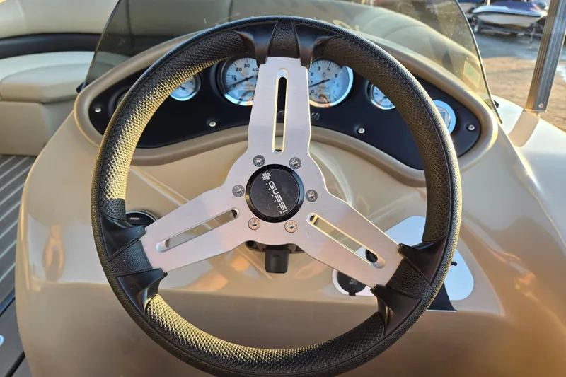 Slide: The Image of Steering wheel of 2016 Manitou 23 Oasis SR boat with dashboard gauges. - 31