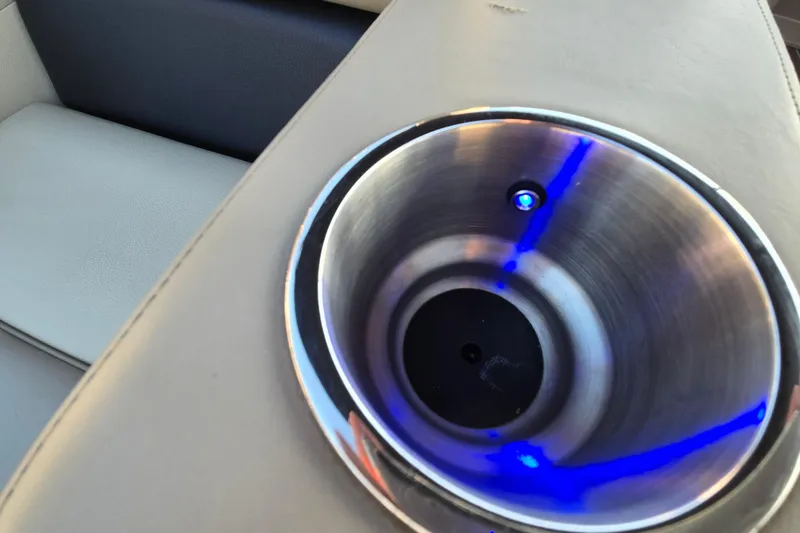 Slide: The Image of Illuminated cup holder in 2016 Manitou 23 Oasis SR boat interior. - 39