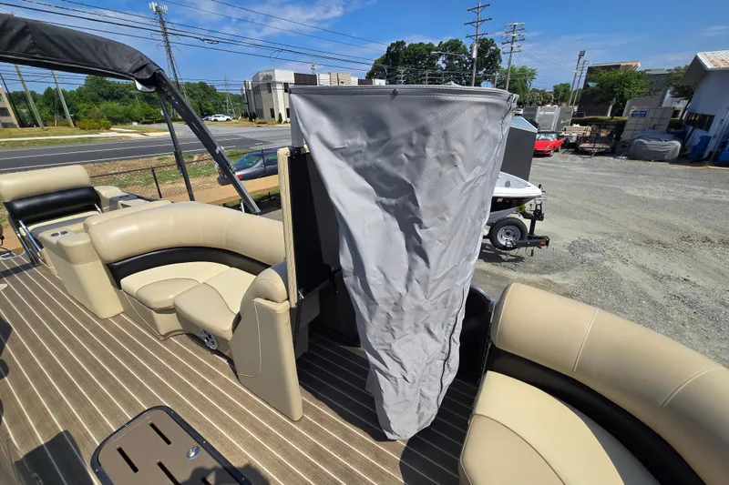 Slide: The Image of 2016 Manitou 23 Oasis SR pontoon boat with beige seating and privacy curtain. - 41