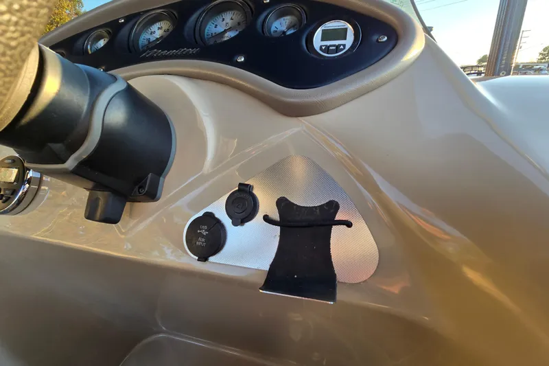 Slide: The Image of Dashboard of a 2016 Manitou 23 Oasis SR boat with gauges and USB port. - 27