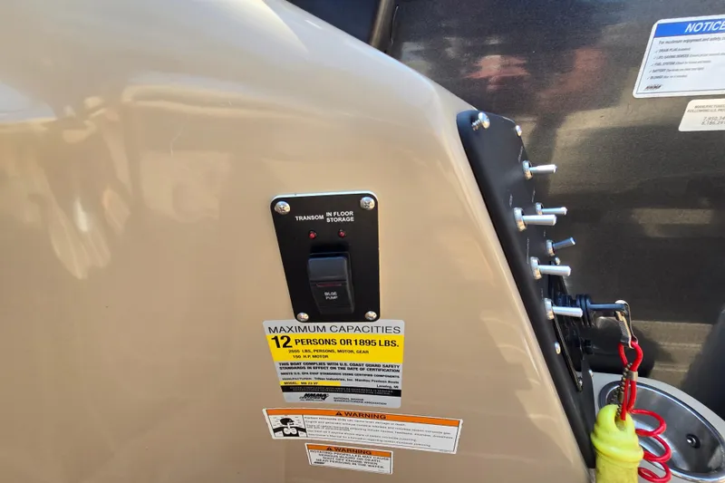 Slide: The Image of 2016 Manitou 23 Oasis SR boat capacity label, showing maximum of 12 persons or 1,895 lbs. - 42