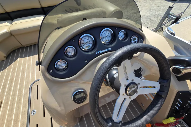 Slide: The Image of Steering console of 2016 Manitou 23 Oasis SR boat with gauges and controls. - 30