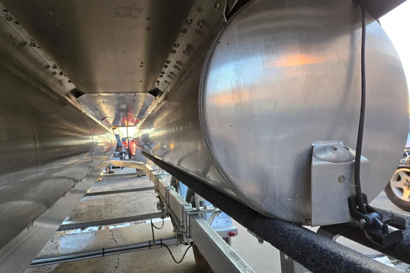 Slide: The Image of Underneath view of a 2016 Manitou 23 Oasis SR pontoon boat on a trailer. - 7