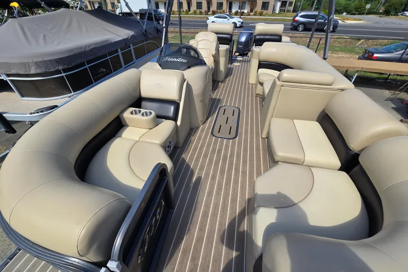 Slide: The Image of 2016 Manitou 23 Oasis SR pontoon boat with spacious beige seating and cup holders. - 9