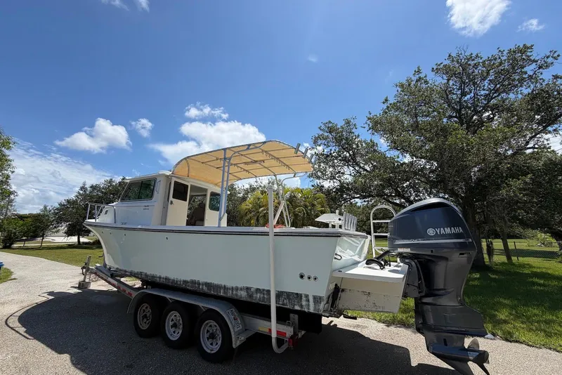 Slide: The Image of 2016 Parker 2820 XLD Sport Cabin boat on trailer with Yamaha outboard motor. - 5