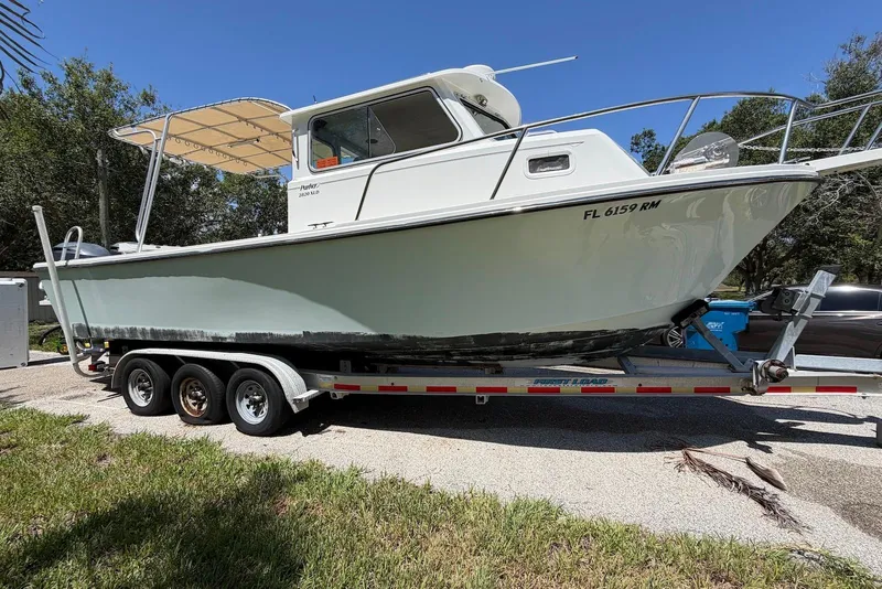 The Image of 2016 Parker 2820 XLD Sport Cabin boat on trailer, parked outdoors. - 0