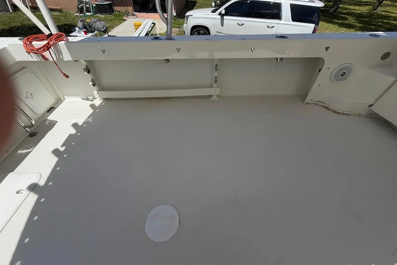 Slide: The Image of 2016 Parker 2820 XLD Sport Cabin boat deck, spacious and clean, with visible storage compartments. - 15