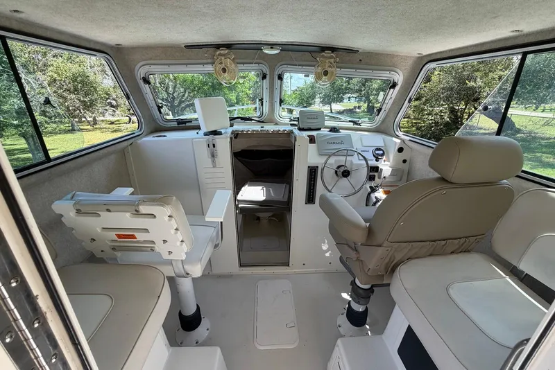 Slide: The Image of Interior of a 2016 Parker 2820 XLD Sport Cabin boat with seating and navigation equipment. - 17