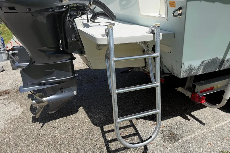 Slide: The Image of Rear view of 2016 Parker 2820 XLD Sport Cabin with ladder and outboard motor. - 8