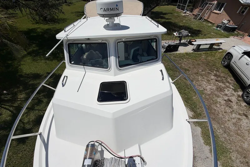 Slide: The Image of 2016 Parker 2820 XLD Sport Cabin boat with Garmin radar, docked outdoors. - 11