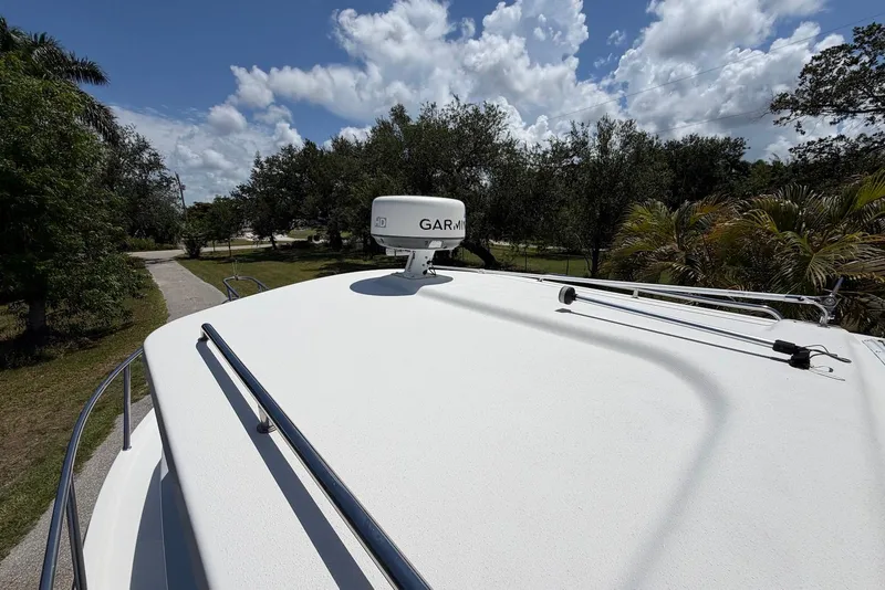 Slide: The Image of 2016 Parker 2820 XLD Sport Cabin boat with Garmin radar, surrounded by lush greenery. - 9