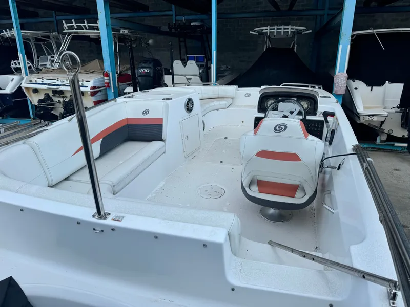 Slide: The Image of The image shows a 2021 Hurricane 188 SunDeck Sport -OB boat with white and gray seating. - 6