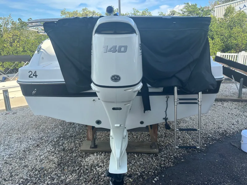 Slide: The Image of A 2021 Hurricane 188 SunDeck Sport -OB with a 140 HP outboard motor, parked on a gravel lot. - 3
