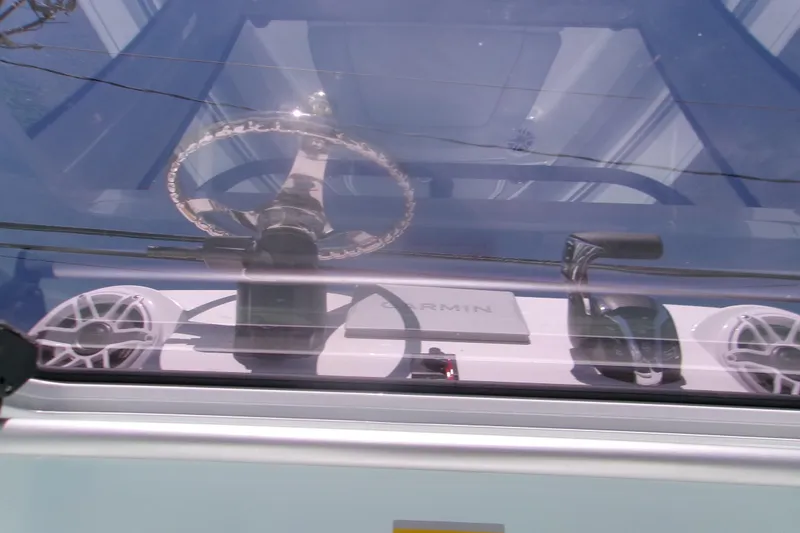 Slide: The Image of Steering wheel and controls of 2027 Sportsman Masters 247OE Bay Boat cockpit. - 8