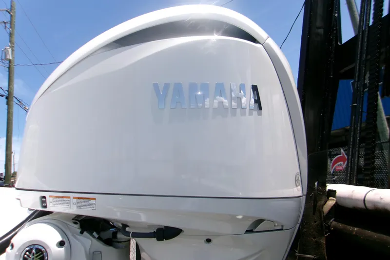 Slide: The Image of Yamaha outboard motor on 2027 Sportsman Masters 247OE Bay Boat under clear sky. - 21