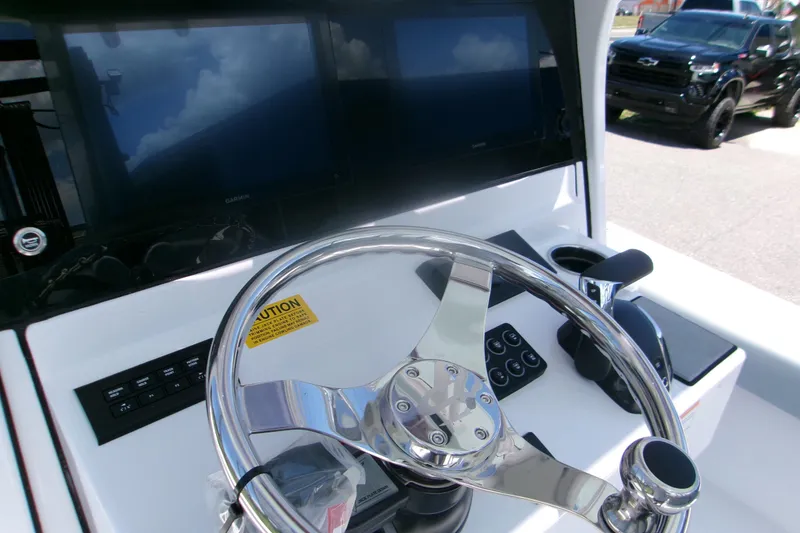 Slide: The Image of Steering console of 2027 Sportsman Masters 247OE Bay Boat with modern controls and displays. - 6