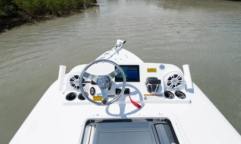Slide: The Image of Manufacturer Provided Image: 2025 Sportsman Masters 247OE Bay Boat dashboard on calm water. - 2