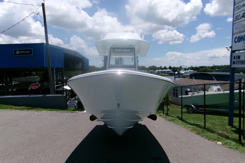 Slide: The Image of 2027 Sportsman Masters 247OE Bay Boat displayed outdoors under a cloudy sky. - 19