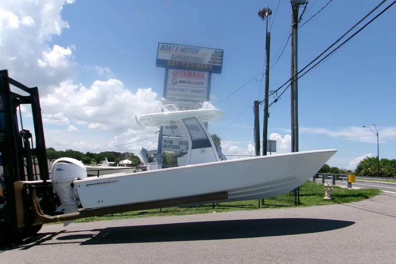 The Image of 2027 Sportsman Masters 247OE Bay Boat on forklift, clear sky background. - 0