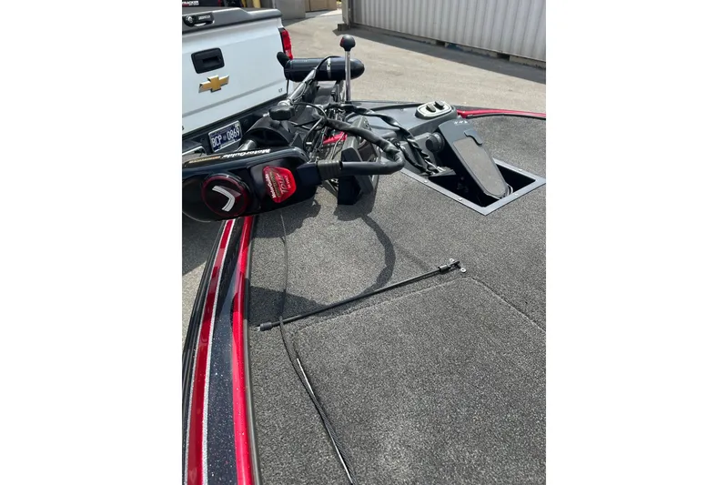Slide: The Image of 2013 Nitro Z-6 boat deck with fishing equipment and a Chevrolet truck nearby. - 5