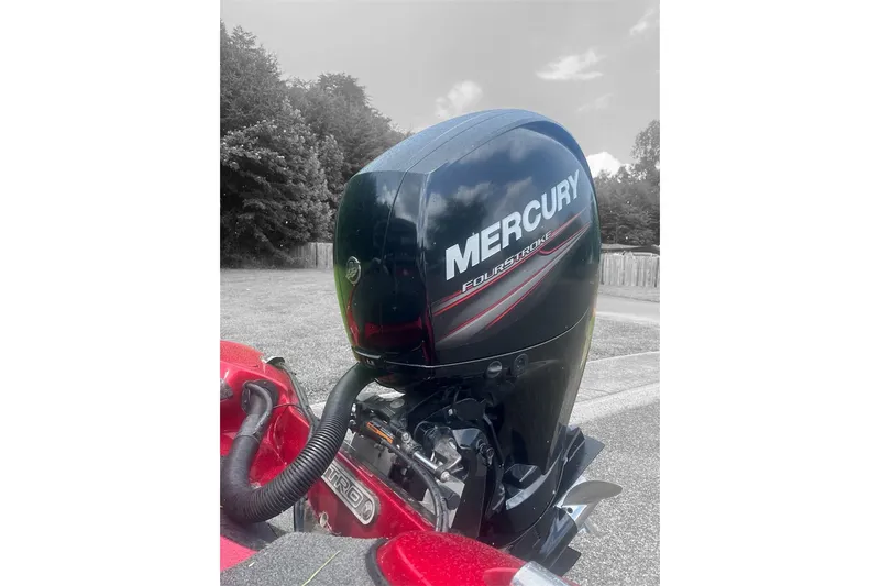 Slide: The Image of 2013 Nitro Z-6 boat with Mercury FourStroke engine, parked outdoors. - 1