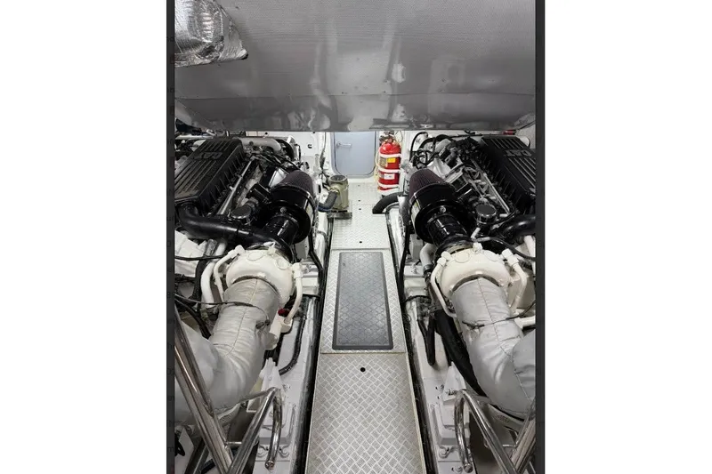 Slide: The Image of Engine room of a 2009 Princess 85 Motor Yacht, featuring dual engines and fire extinguisher. - 16