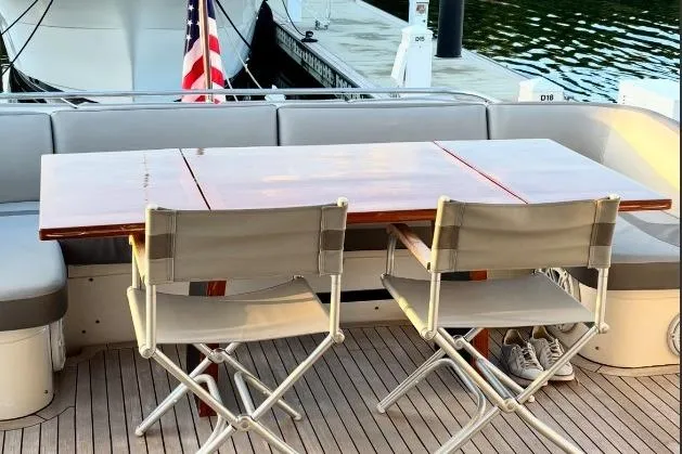 Slide: The Image of Outdoor dining area on 2009 Princess 85 Motor Yacht with wooden table and folding chairs. - 8