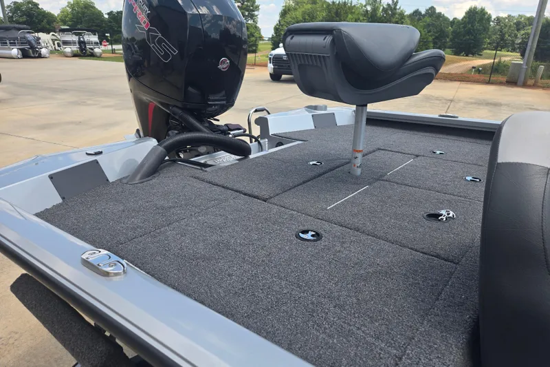Slide: The Image of 2023 Vexus AVX1980C boat deck with seating and motor, parked outdoors. - 13