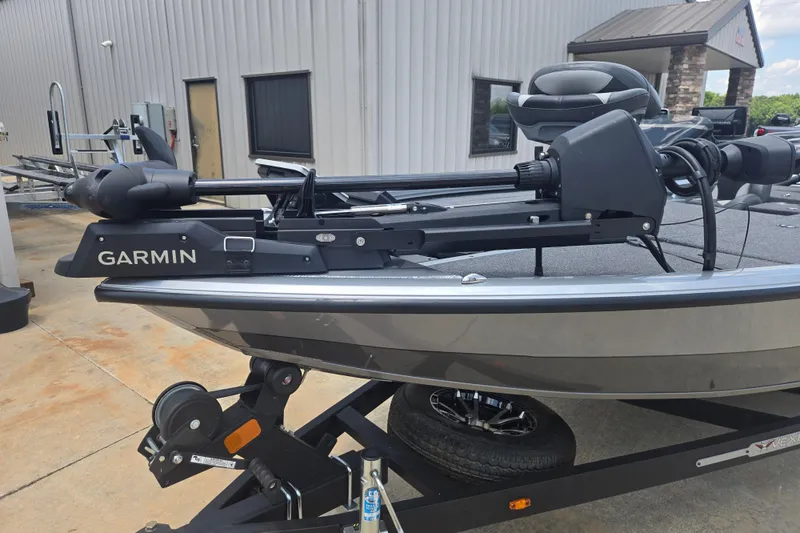 Slide: The Image of 2023 Vexus AVX1980C boat with Garmin equipment, parked on a trailer outside a building. - 7