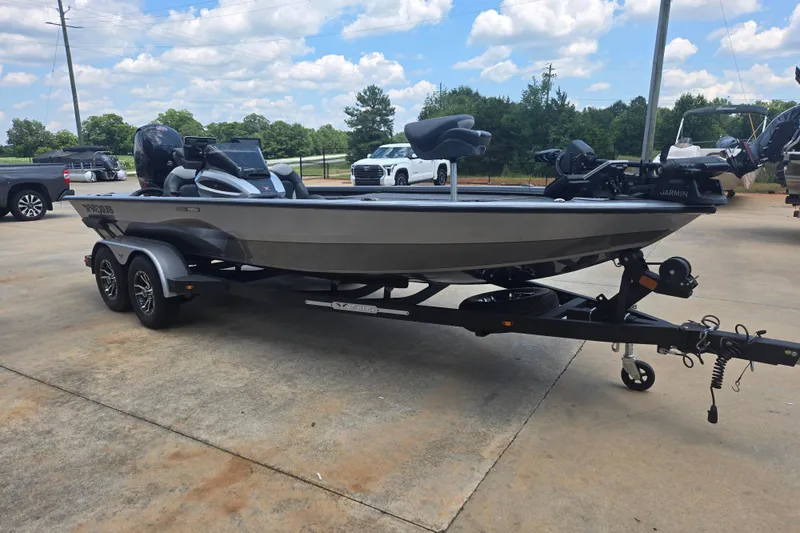 Slide: The Image of 2023 Vexus AVX1980C fishing boat on trailer, parked outdoors under a blue sky. - 5