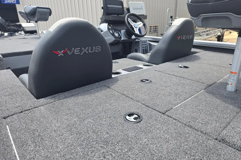 Slide: The Image of 2023 Vexus AVX1980C boat interior with gray carpet and dual seats. - 18