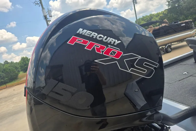 Slide: The Image of Mercury Pro XS 150 engine on 2023 Vexus AVX1980C boat, outdoors under blue sky. - 14