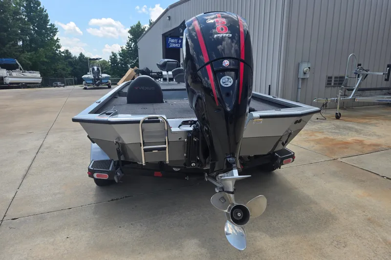 Slide: The Image of 2023 Vexus AVX1980C boat with powerful outboard motor, parked outdoors. - 3