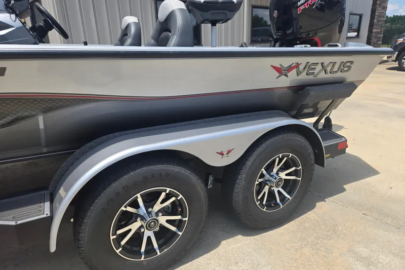 Slide: The Image of 2023 Vexus AVX1980C boat on trailer, featuring sleek design and dual wheels. - 22