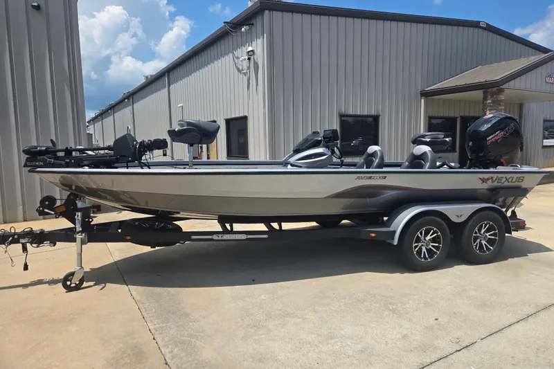 The Image of 2023 Vexus AVX1980C boat on trailer, parked outside a metal building under a blue sky. - 1