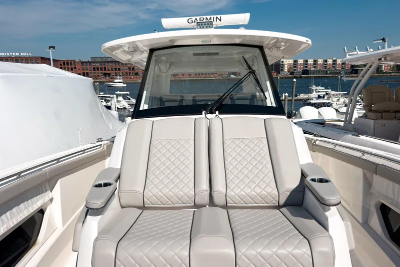 Slide: The Image of 2023 Pursuit S 378 Sport boat with luxurious seating, docked in a marina. - 8