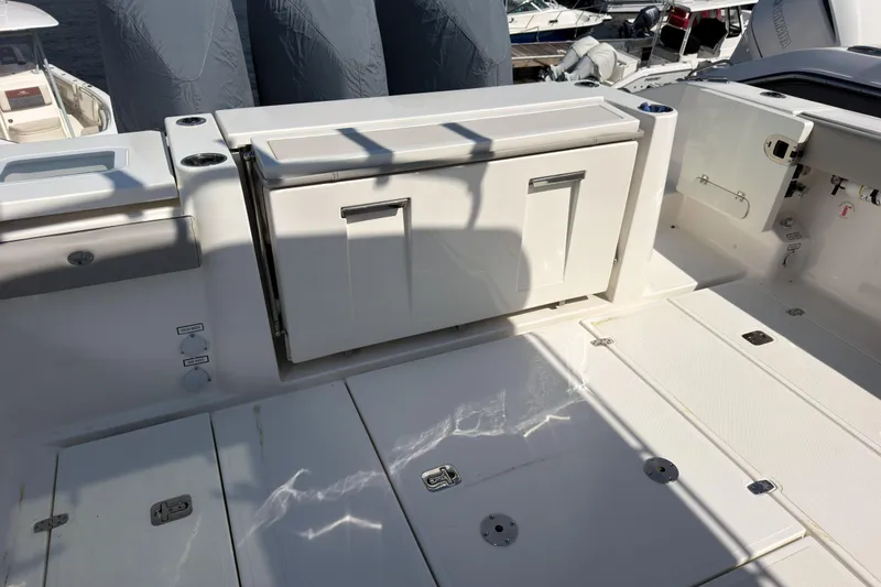 Slide: The Image of 2023 Pursuit S 378 Sport boat deck with storage compartments and seating area. - 1