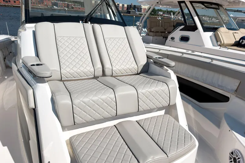 Slide: The Image of Luxurious seating on 2023 Pursuit S 378 Sport boat, featuring quilted upholstery and cup holders. - 7