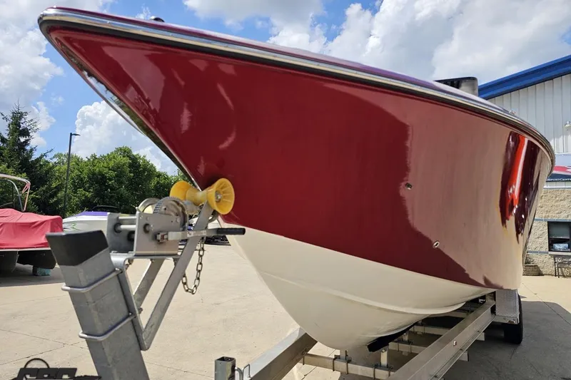 Slide: The Image of 2005 Fountain 34 Sportfish CC Open Bow on trailer, red hull, sunny day. - 17