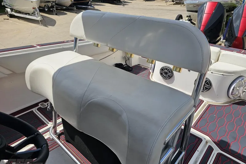 Slide: The Image of 2005 Fountain 34 Sportfish CC Open Bow boat interior with white seating and speakers. - 71