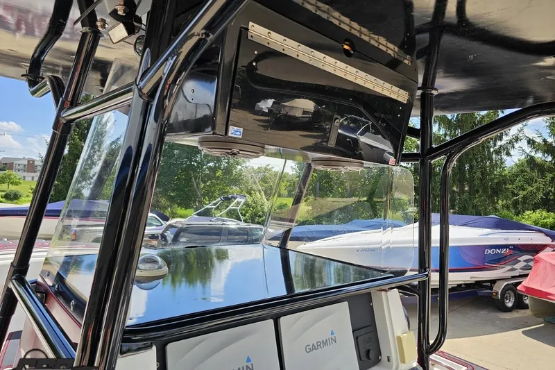 Slide: The Image of 2005 Fountain 34 Sportfish CC Open Bow with Garmin electronics, docked near other boats. - 73
