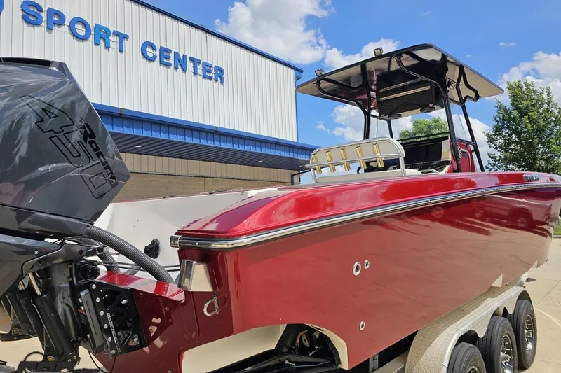 Slide: The Image of Red 2005 Fountain 34 Sportfish CC Open Bow boat at a sport center, under a clear sky. - 35