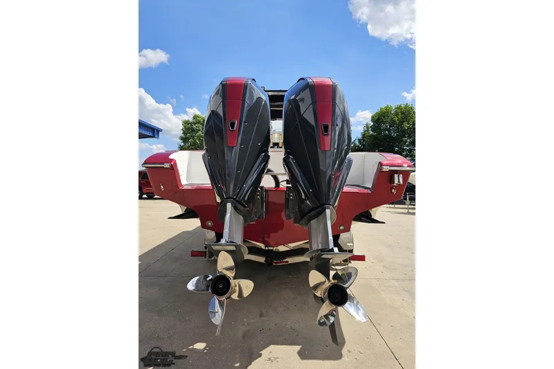 Slide: The Image of 2005 Fountain 34 Sportfish CC Open Bow with dual outboard motors, docked under blue sky. - 30