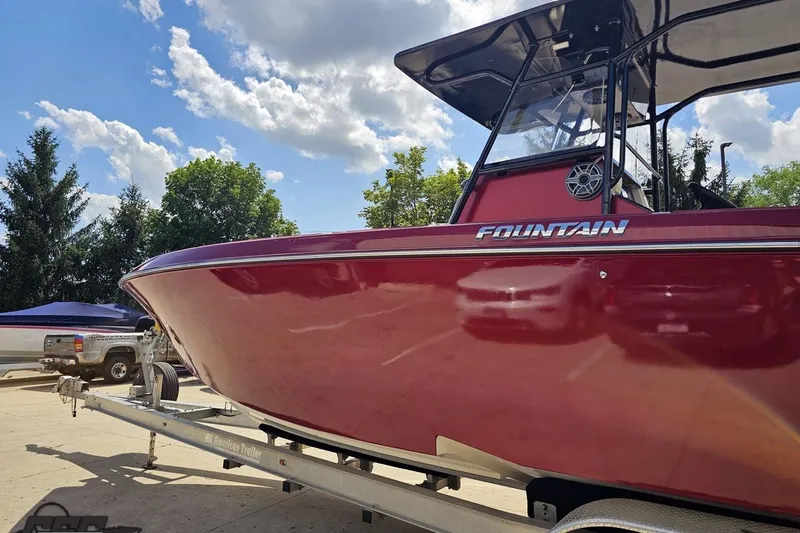 Slide: The Image of 2005 Fountain 34 Sportfish CC Open Bow boat on trailer under blue sky. - 23