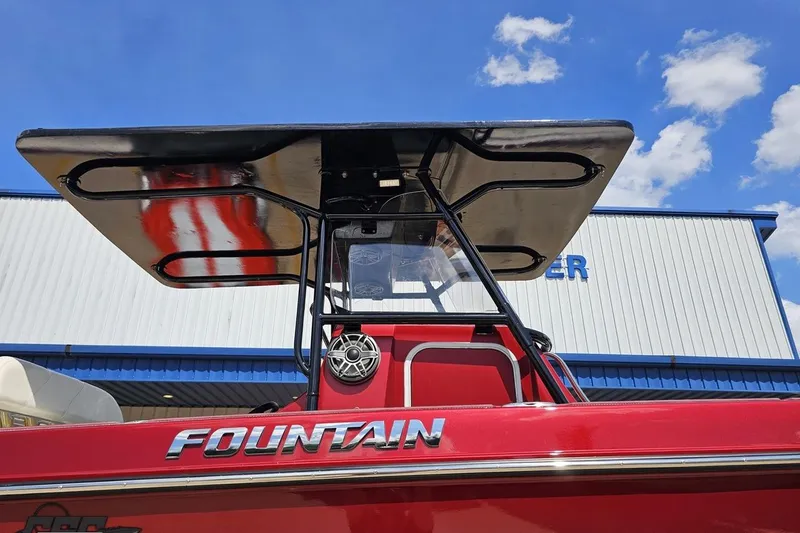 Slide: The Image of 2005 Fountain 34 Sportfish CC Open Bow boat with T-top against blue sky. - 5