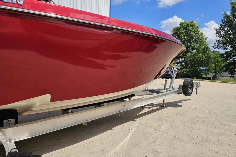 Slide: The Image of Red 2005 Fountain 34 Sportfish CC Open Bow boat on trailer, sunny day. - 6