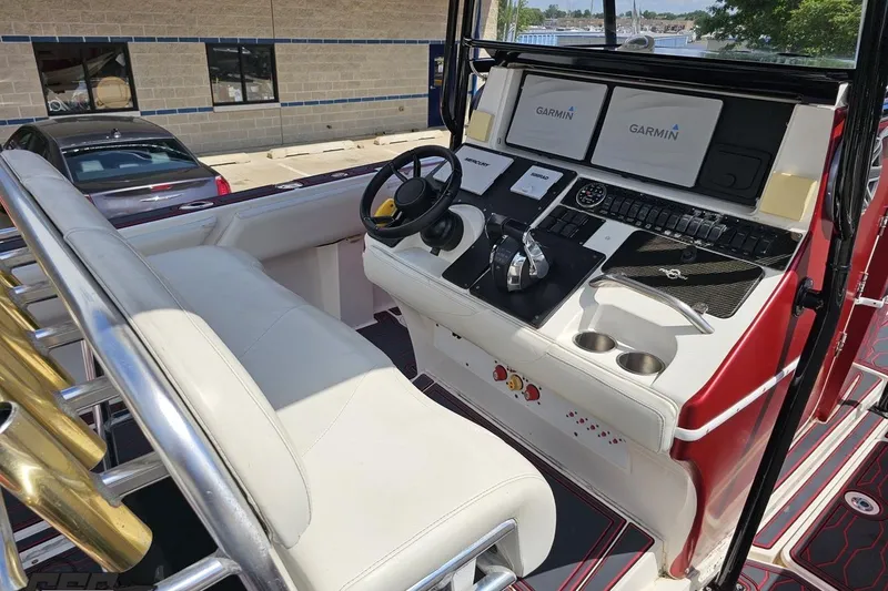 Slide: The Image of 2005 Fountain 34 Sportfish CC Open Bow boat dashboard with Garmin navigation displays. - 62