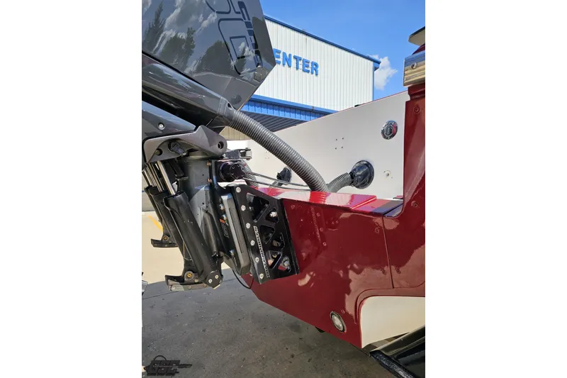 Slide: The Image of 2005 Fountain 34 Sportfish CC Open Bow boat engine detail with red and white hull. - 37