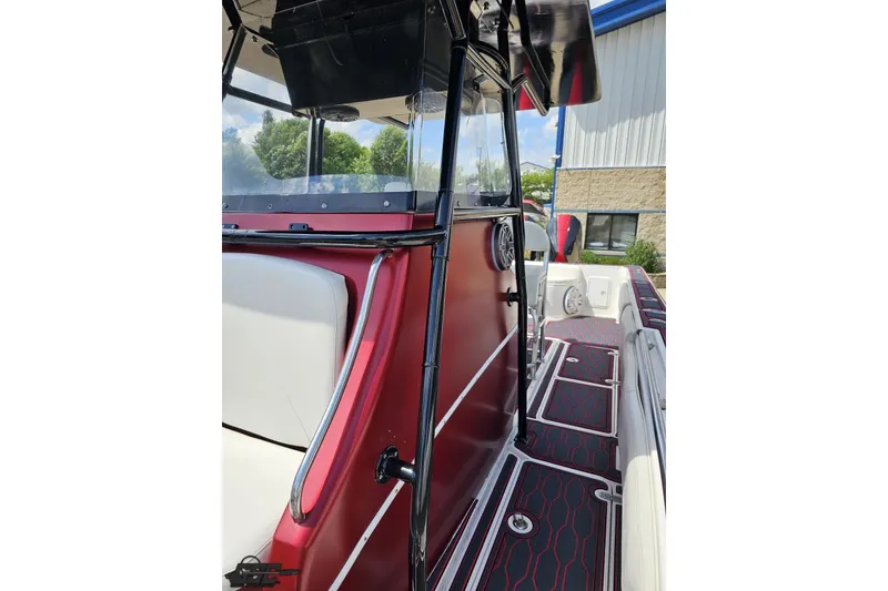 Slide: The Image of 2005 Fountain 34 Sportfish CC Open Bow, sleek red and white interior, docked outdoors. - 88