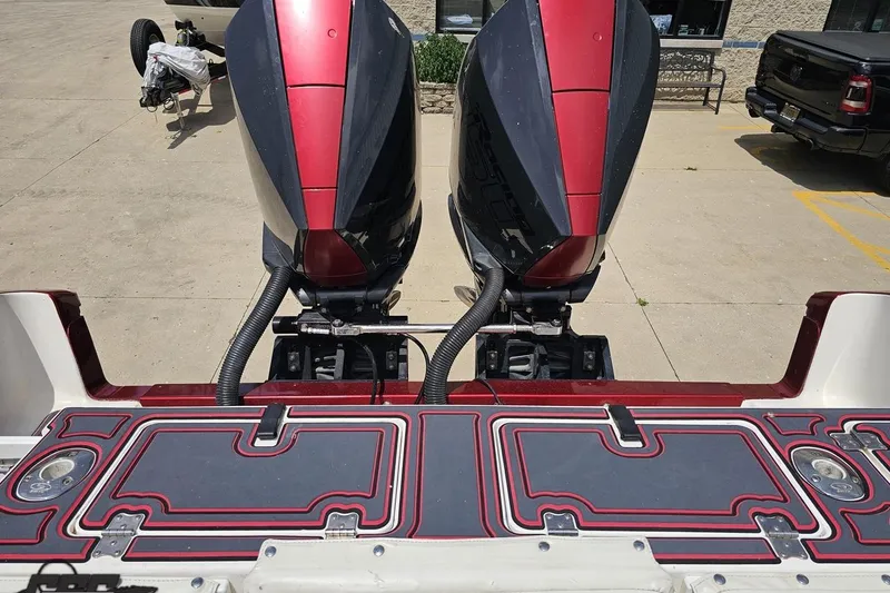 Slide: The Image of 2005 Fountain 34 Sportfish CC Open Bow with dual outboard motors, docked on pavement. - 94